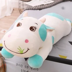 La compagnie de la peluche Peluche vache coloré qui broute de l'herbe