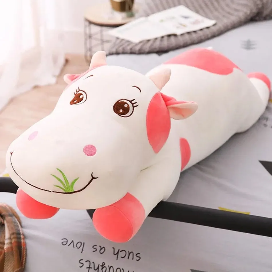 La compagnie de la peluche Peluche vache coloré qui broute de l'herbe